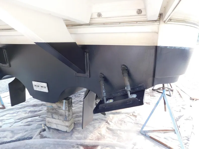 Slide: The Image of 2005 Cruisers Yachts 500 Express hull on stands, showing underside details and supports. - 7