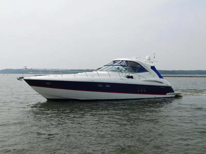 Slide: The Image of 2005 Cruisers Yachts 500 Express on calm water, showcasing sleek design and luxury features. - 0