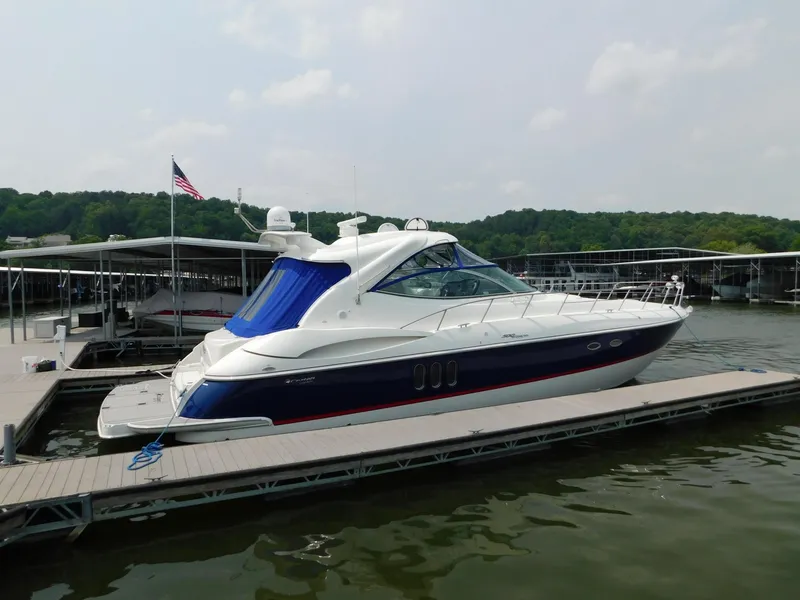 Slide: The Image of 2005 Cruisers Yachts 500 Express docked at a marina, featuring sleek design and blue accents. - 1