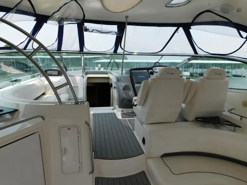 Slide: The Image of 2005 Cruisers Yachts 500 Express cockpit with modern helm, seating, and panoramic windows. - 18