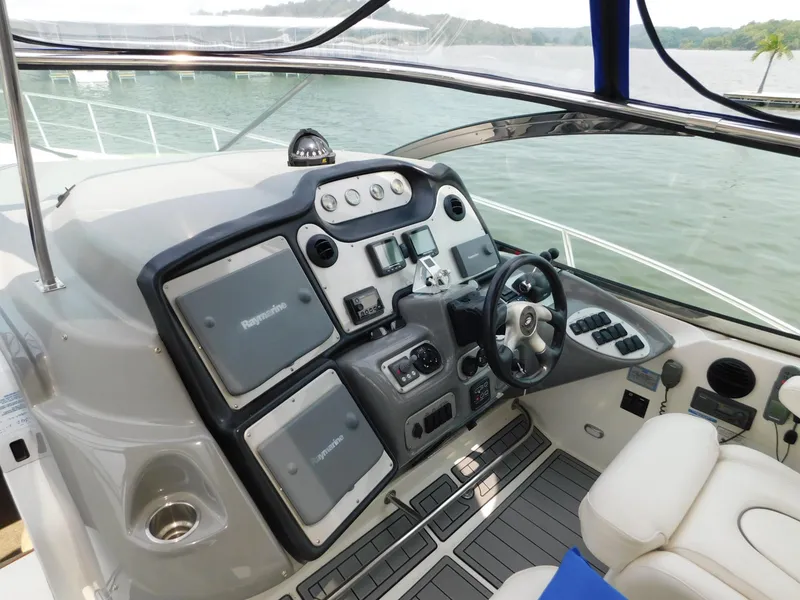 Slide: The Image of 2005 Cruisers Yachts 500 Express helm with modern navigation equipment and luxurious seating. - 20