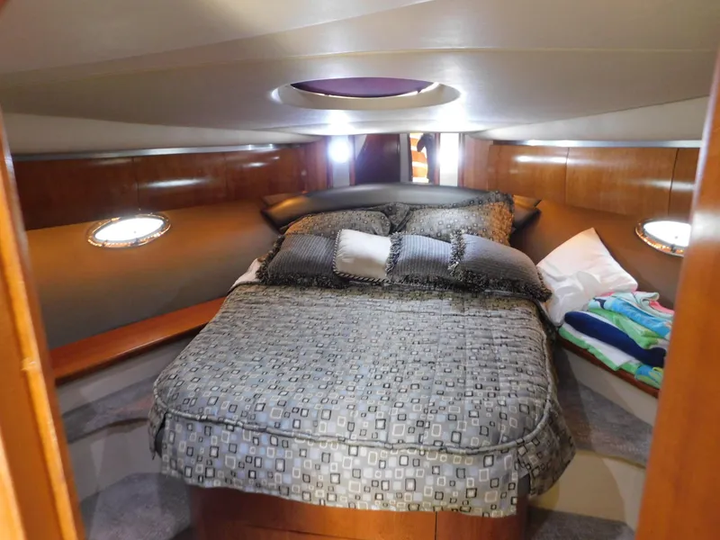 Slide: The Image of Luxurious cabin interior of 2005 Cruisers Yachts 500 Express with cozy bedding. - 24