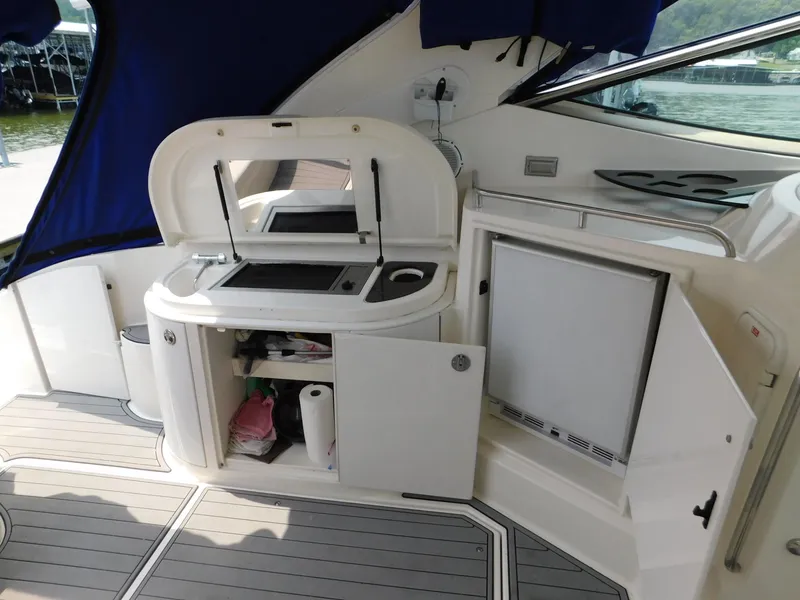 Slide: The Image of 2005 Cruisers Yachts 500 Express interior with kitchenette and storage compartments. - 25