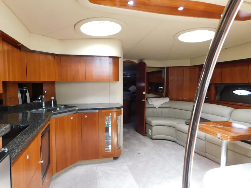Slide: The Image of Luxurious 2005 Cruisers Yachts 500 Express interior with elegant wood cabinetry and plush seating. - 26
