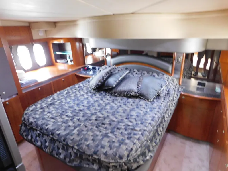 Slide: The Image of Luxurious cabin interior of 2005 Cruisers Yachts 500 Express with plush bedding and wood finishes. - 30