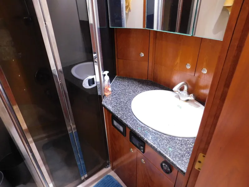 Slide: The Image of Luxurious bathroom in 2005 Cruisers Yachts 500 Express with modern sink and shower. - 39