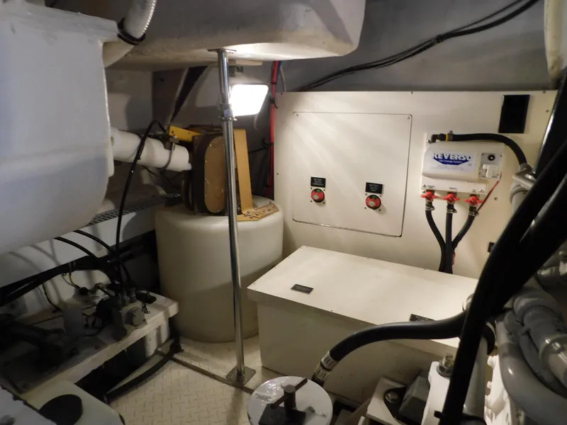 Slide: The Image of Engine room of 2005 Cruisers Yachts 500 Express, featuring control panels and mechanical components. - 43