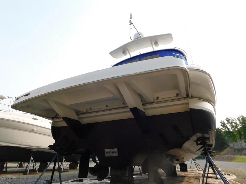 Slide: The Image of 2005 Cruisers Yachts 500 Express on dry dock, showcasing hull and design. - 45