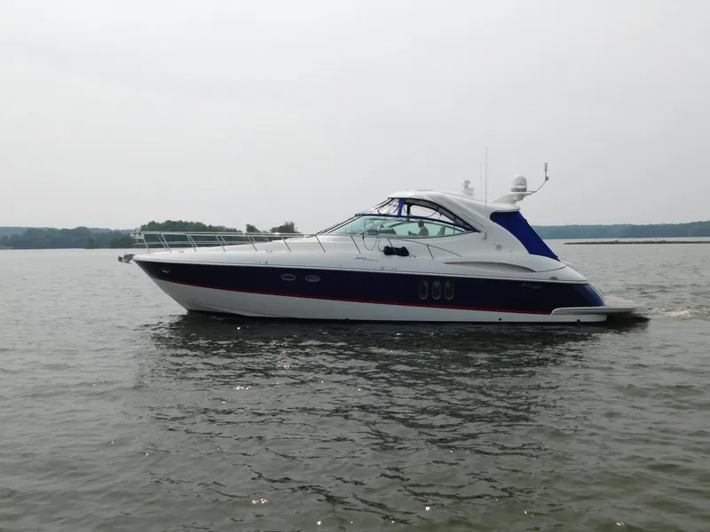 Slide: The Image of 2005 Cruisers Yachts 500 Express on calm water, side view. - 46