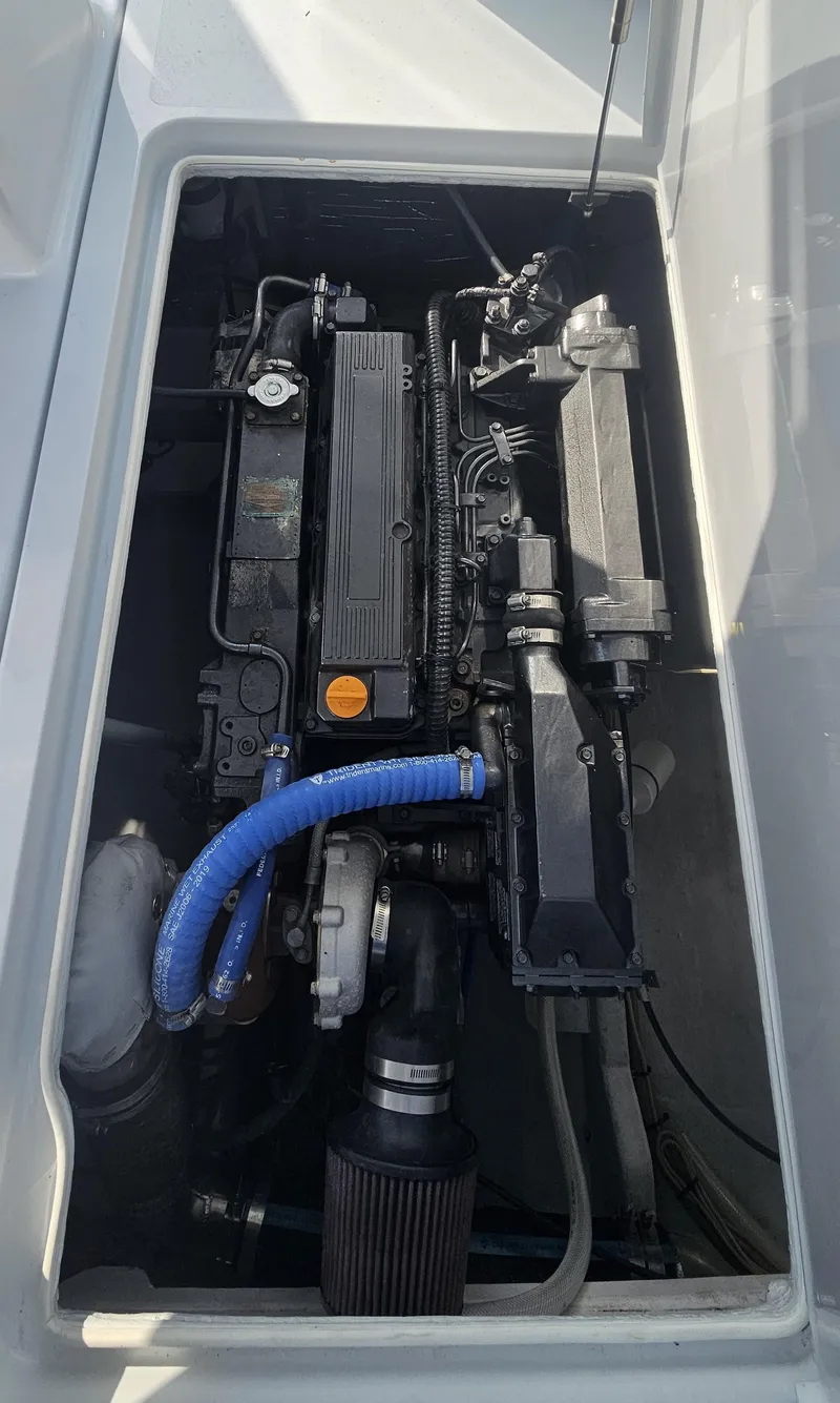 Slide: The Image of Engine compartment of a 1994 Tides 27 Sportfish boat, showcasing mechanical components. - 7
