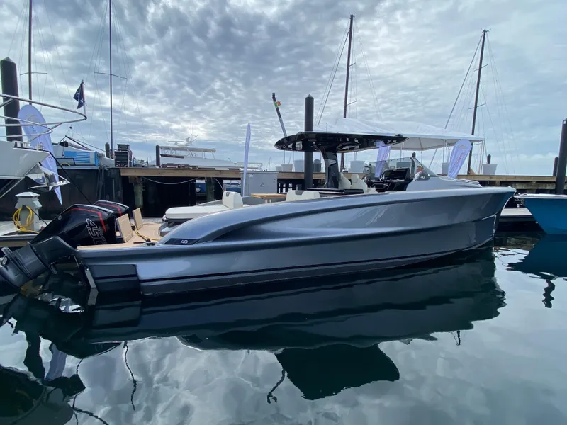 Slide: The Image of 2024 Solaris Power 40F Open yacht docked in marina under cloudy sky. - 16