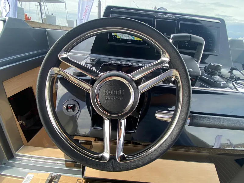 Slide: The Image of Steering wheel of 2024 Solaris Power 40F Open yacht, featuring modern dashboard controls. - 24