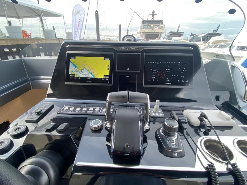 Slide: The Image of 2024 Solaris Power 40F open yacht dashboard with navigation screens and controls. - 25