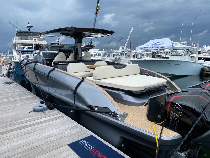 Slide: The Image of 2024 Solaris Power 40F Open yacht docked, featuring sleek design and spacious seating. - 7