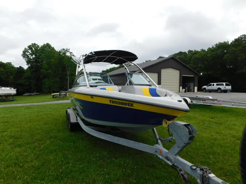 Slide: The Image of 2004 Moomba 23XLV boat on trailer, parked on grass near a building. - 10