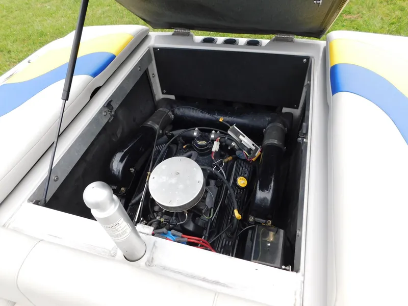 Slide: The Image of 2004 Moomba 23XLV boat engine compartment with open hatch, showcasing engine components. - 13