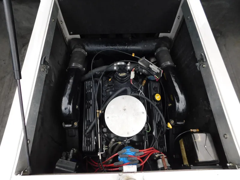 Slide: The Image of 2004 Moomba 23XLV boat engine compartment with visible components and wiring. - 17