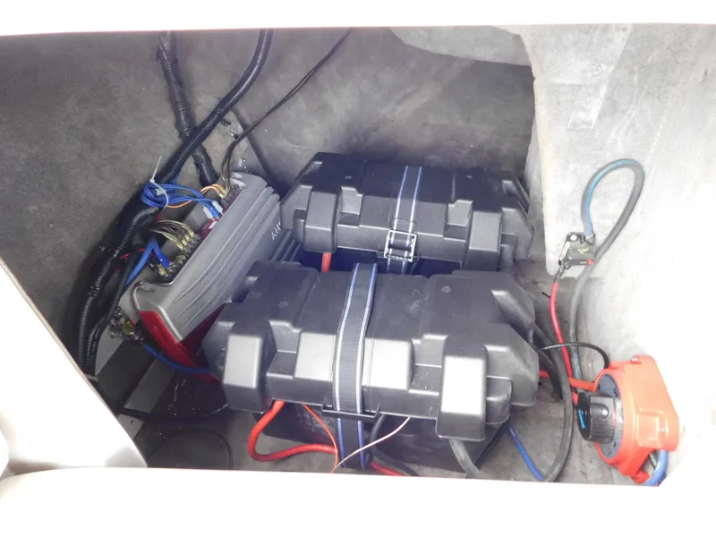 Slide: The Image of 2004 Moomba 23XLV boat battery compartment with wiring and components. - 19