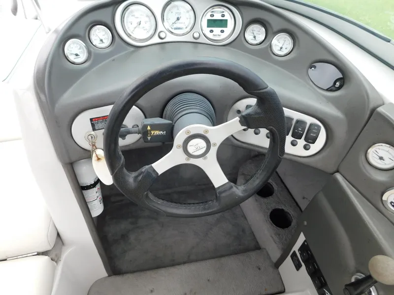 Slide: The Image of 2004 Moomba 23XLV boat dashboard with steering wheel and gauges. - 22