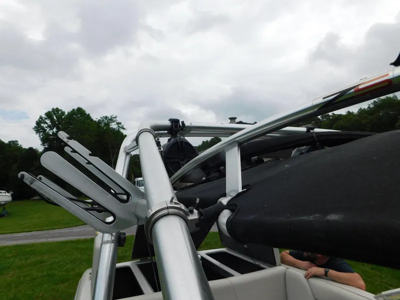 Slide: The Image of 2004 Moomba 23XLV boat with wakeboard tower and racks, set against a cloudy sky. - 25