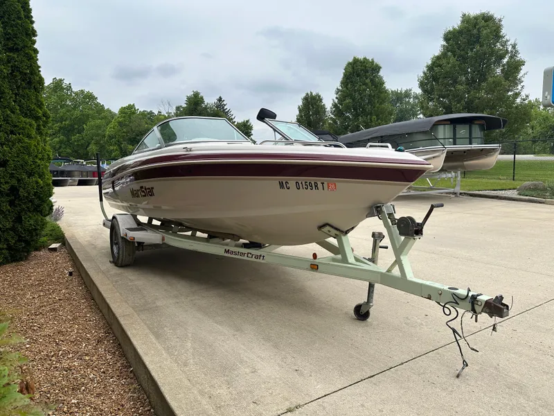 Slide: The Image of 1999 MasterCraft MariStar 210 VRS boat on trailer, parked outdoors. - 1