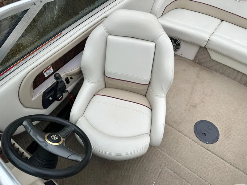 Slide: The Image of 1999 MasterCraft MariStar 210 VRS boat interior with white captain's chair and steering wheel. - 11