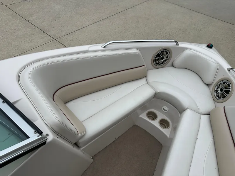 Slide: The Image of 1999 MasterCraft MariStar 210 VRS boat interior with white seating and cup holders. - 15