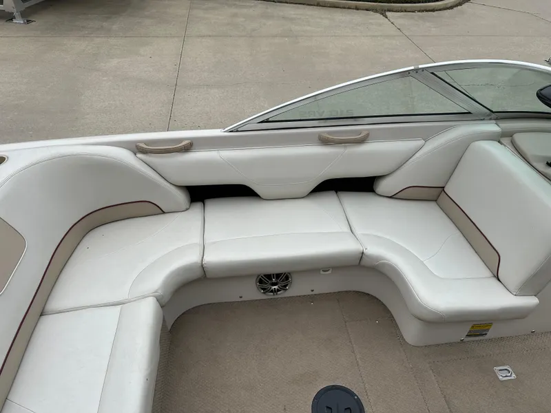 Slide: The Image of 1999 MasterCraft MariStar 210 VRS boat interior with white seating and speaker. - 7