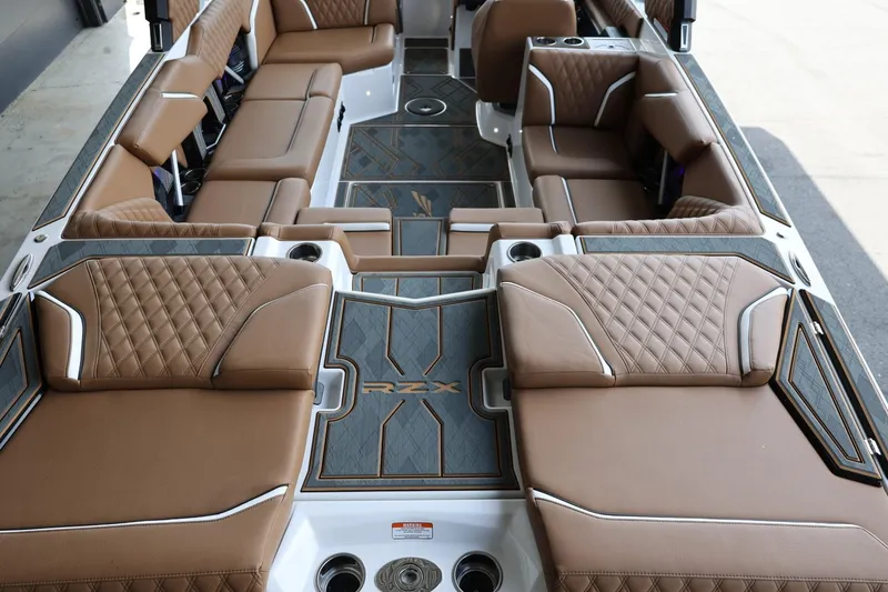Slide: The Image of 2025 Tigé 24RZX boat interior with luxurious brown seating and modern design. - 10