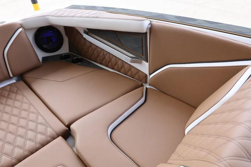 Slide: The Image of 2025 Tigé 24RZX boat interior with luxurious brown leather seating and modern design. - 17
