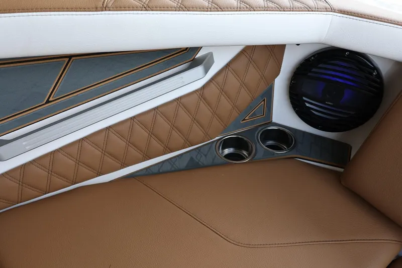 Slide: The Image of 2025 Tigé 24RZX interior with brown leather, speaker, and cup holders. - 22
