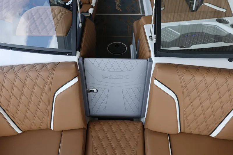 Slide: The Image of Luxurious interior of 2025 Tigé 24RZX boat with tan diamond-stitched seats. - 25