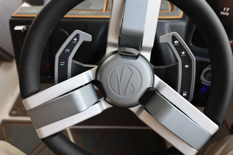 Slide: The Image of Steering wheel of 2025 Tigé 24RZX boat with control buttons. - 28