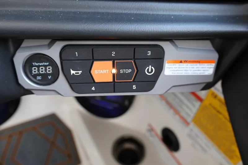 Slide: The Image of Control panel of 2025 Tigé 24RZX boat with start and stop buttons. - 30
