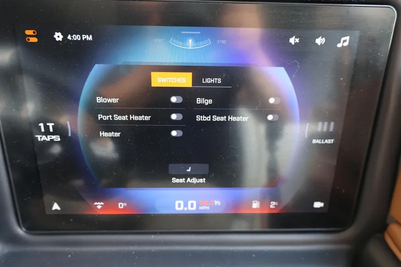 Slide: The Image of Touchscreen control panel of 2025 Tigé 24RZX boat, displaying switches and settings. - 34