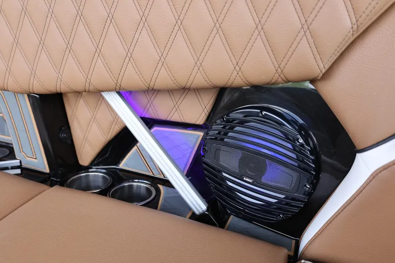 Slide: The Image of 2025 Tigé 24RZX interior with diamond-stitched seats, speaker, and cup holders. - 38