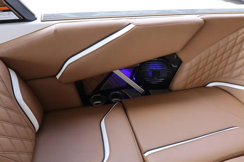 Slide: The Image of 2025 Tigé 24RZX interior with brown leather seats and modern speaker system. - 40