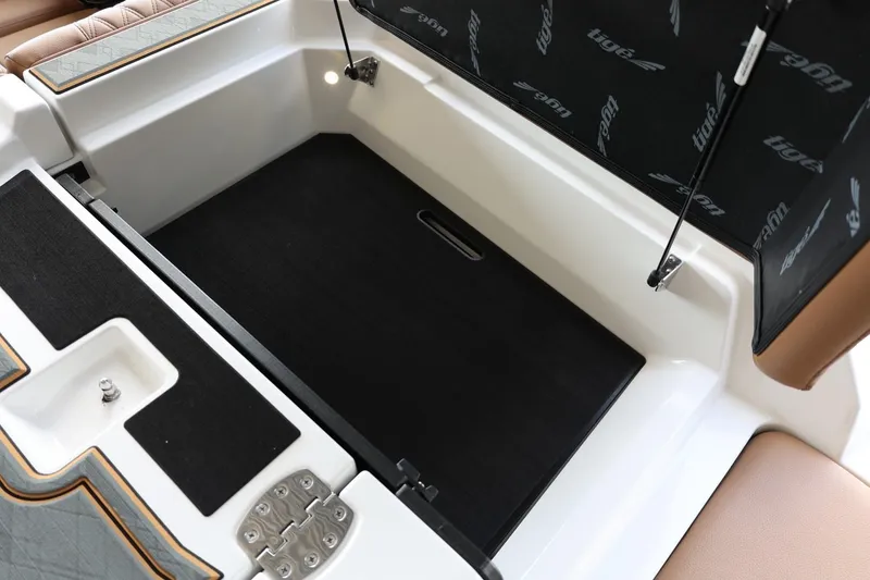 Slide: The Image of 2025 Tigé 24RZX boat storage compartment with open lid and sleek interior design. - 49