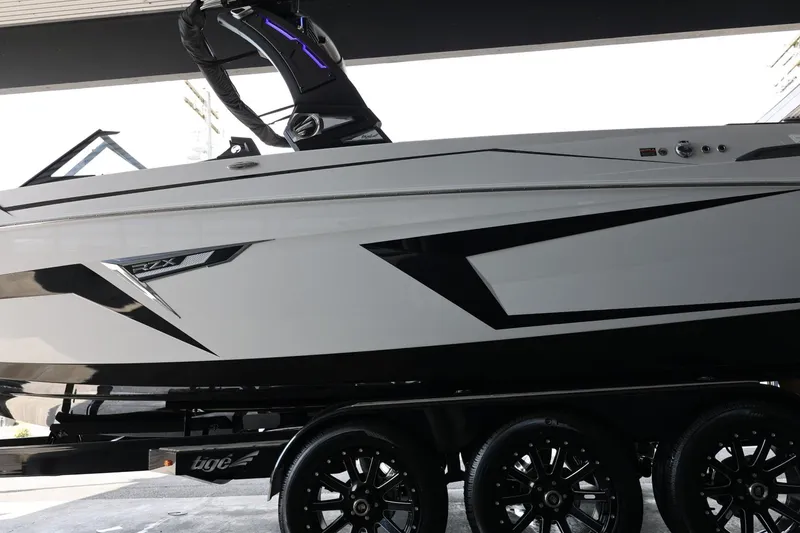 Slide: The Image of 2025 Tigé 24RZX boat on trailer, sleek design with black and white accents. - 5
