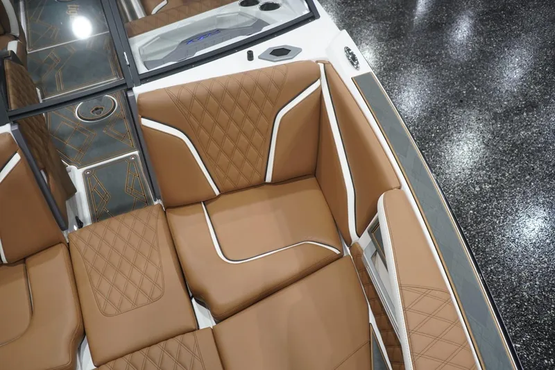 Slide: The Image of Luxurious brown seating in 2025 Tigé 24RZX boat interior. - 57