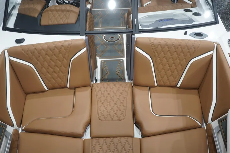 Slide: The Image of Luxurious interior of 2025 Tigé 24RZX boat with brown diamond-stitched seating. - 58