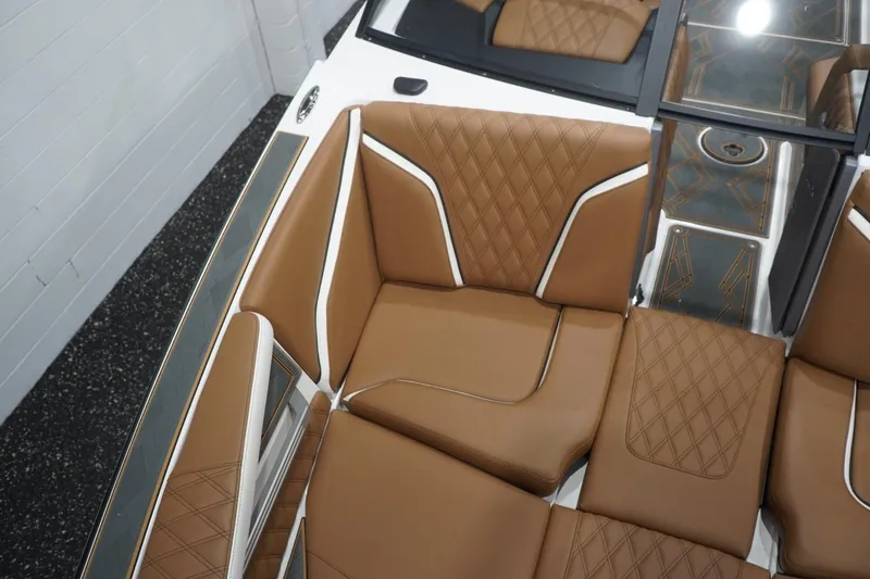 Slide: The Image of 2025 Tigé 24RZX boat interior with brown diamond-stitched leather seating. - 59
