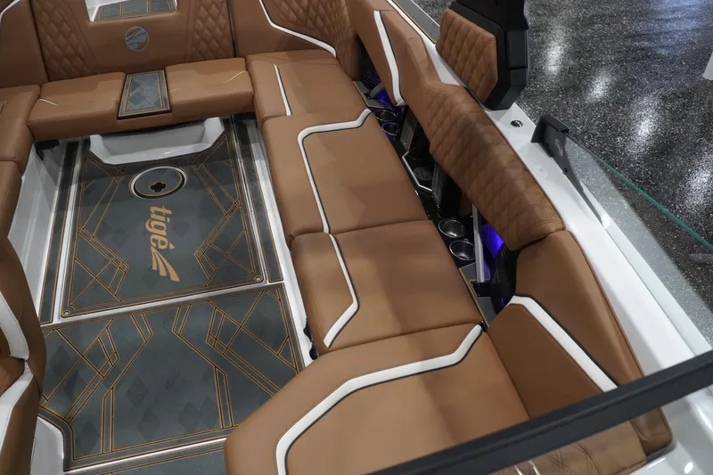 Slide: The Image of Luxurious interior of 2025 Tigé 24RZX boat with brown leather seating and stylish flooring. - 61