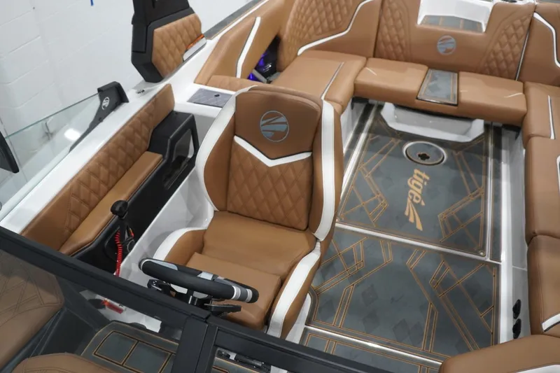 Slide: The Image of Luxurious interior of 2025 Tigé 24RZX boat with brown leather seating and stylish flooring. - 62