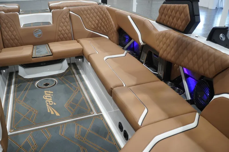 Slide: The Image of Luxurious interior of 2025 Tigé 24RZX boat with brown leather seating and modern design. - 63