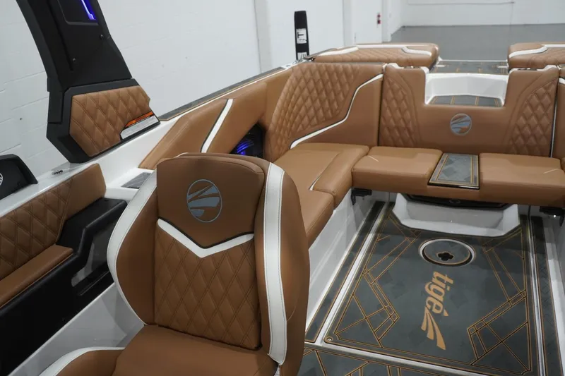 Slide: The Image of Luxurious interior of 2025 Tigé 24RZX boat with brown quilted seating. - 64