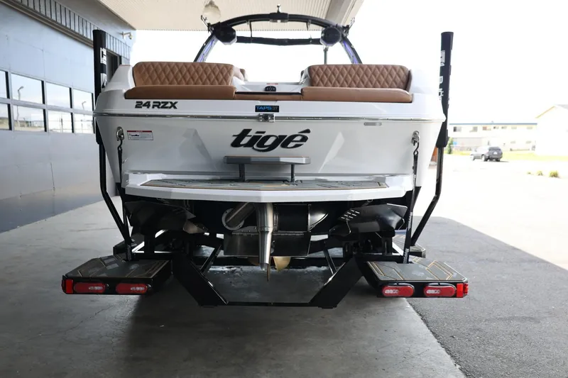 Slide: The Image of 2025 Tigé 24RZX boat rear view with dual swim platforms and stylish seating. - 7