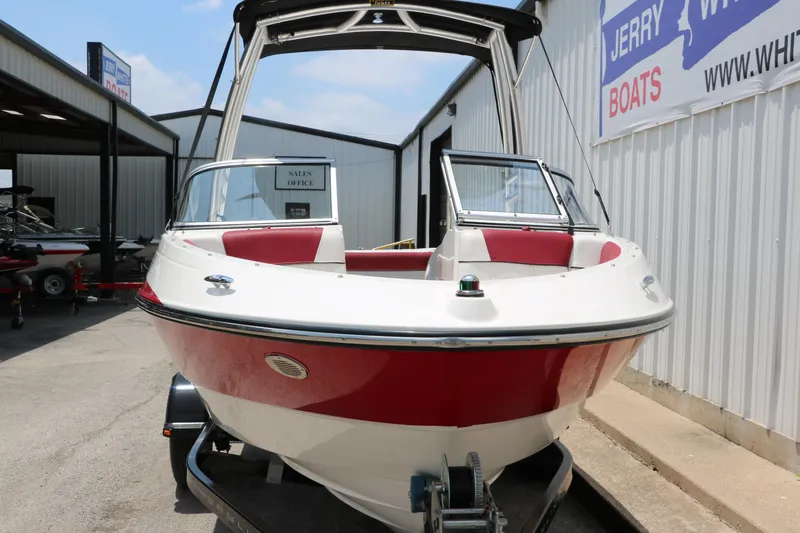 Slide: The Image of 2014 Bayliner 185 BR boat with red and white exterior, displayed at a dealership. - 10