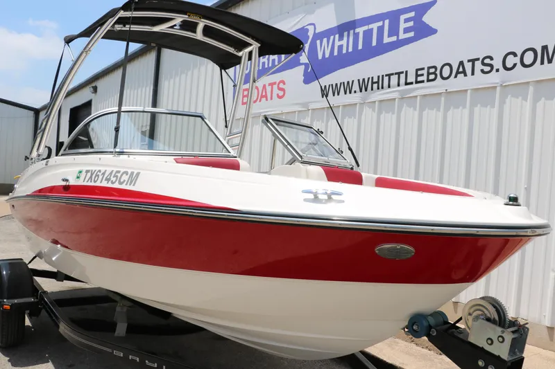 Slide: The Image of 2014 Bayliner 185 BR boat with red and white design on a trailer at Whittle Boats. - 11