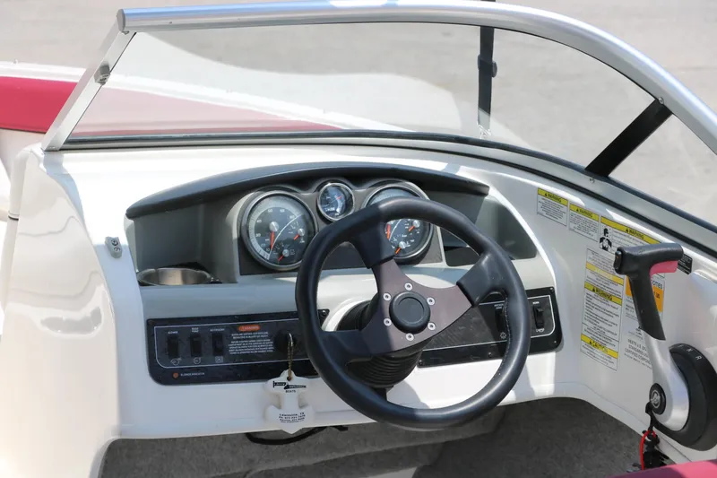 Slide: The Image of 2014 Bayliner 185 BR dashboard with steering wheel and gauges. - 16